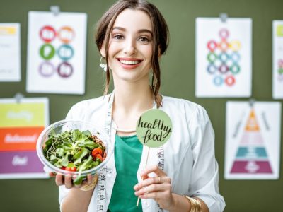 portrait-of-a-woman-dietitian-with-schemes-on-the-topic-of-nutrition.